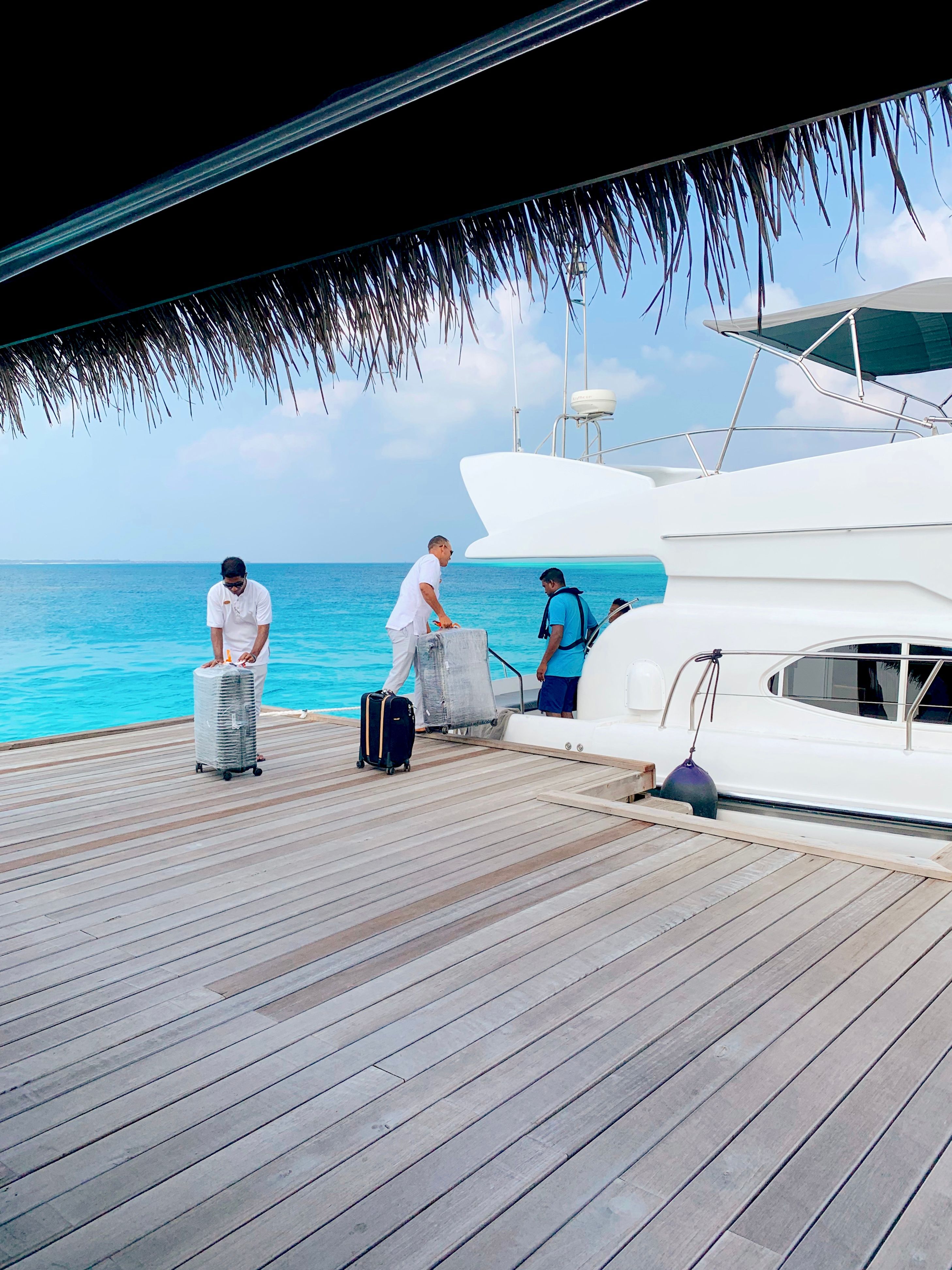 Speedboat crew loading luggage onto the boat